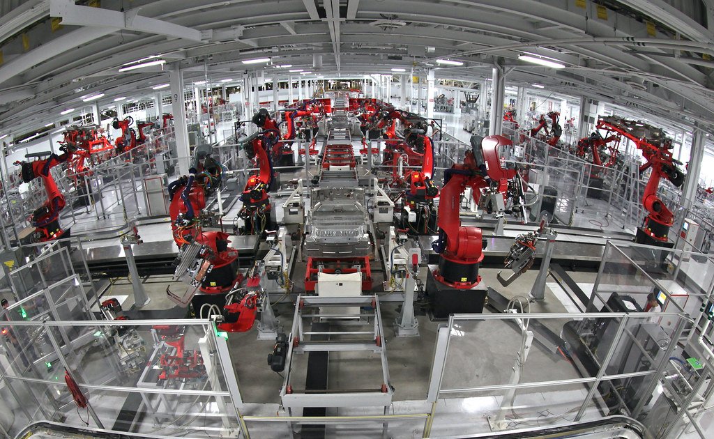 Robotic arms working along an automotive assembly line