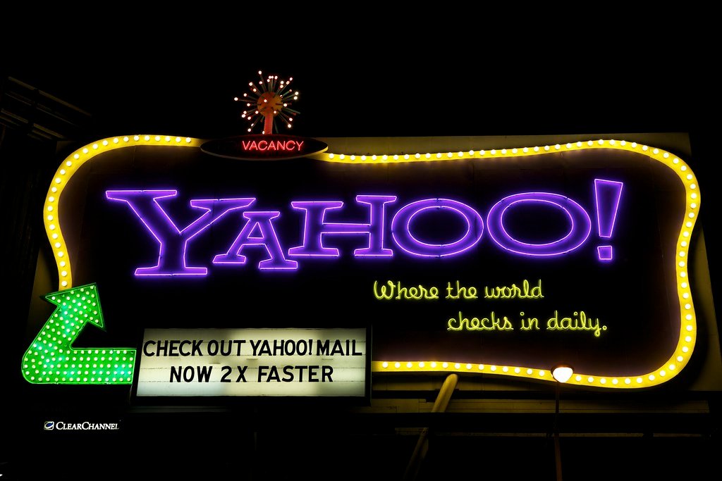 A large advertising billboard above a city street