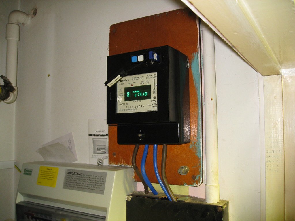 A domestic electricity meter with the dials running