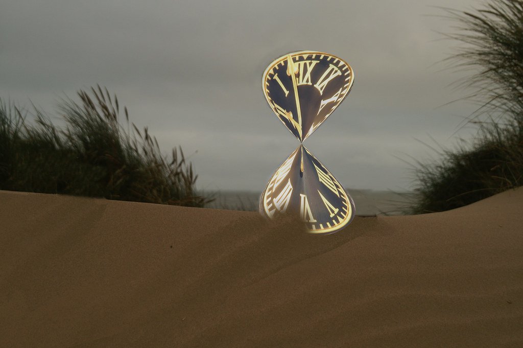 An hourglass measuring time as sand runs through it