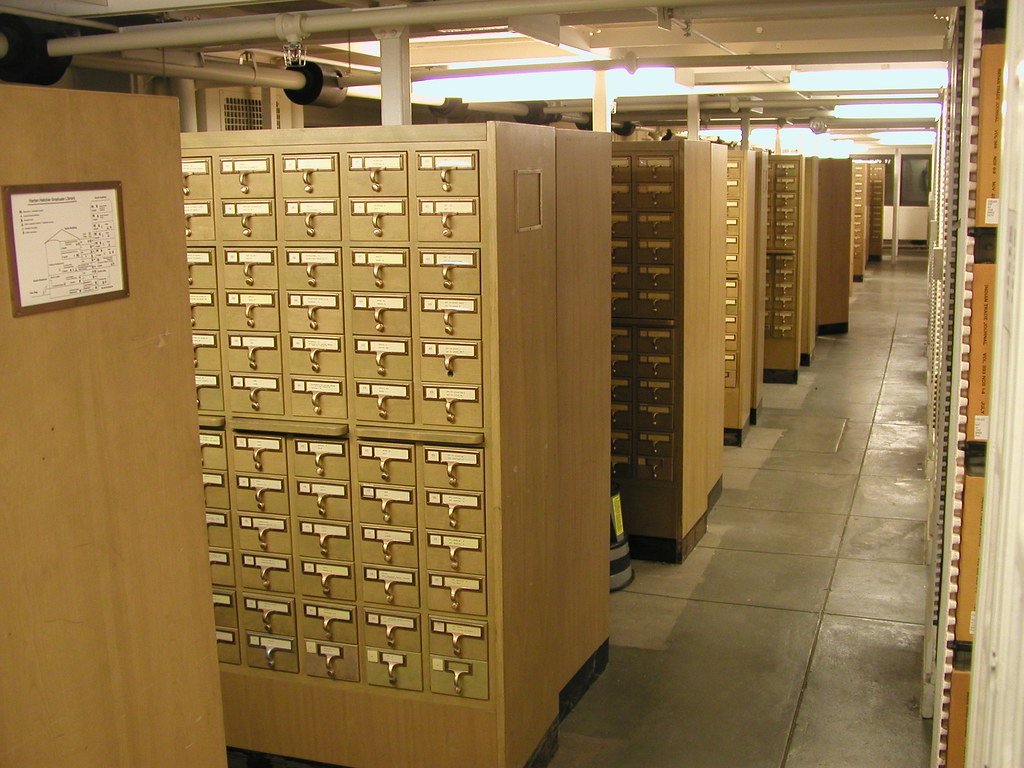 Rows of wooden library card catalog drawers