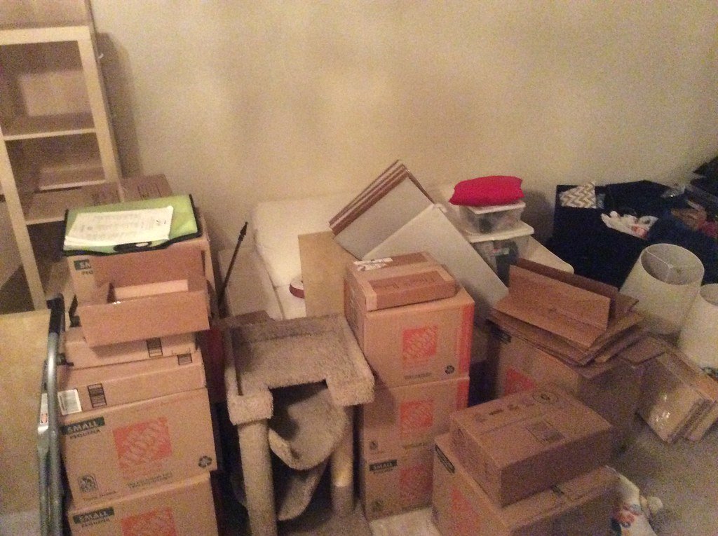A room stacked with moving boxes during a clear-out