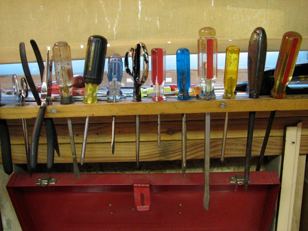 A rack of hand tools, each one hung in its own place