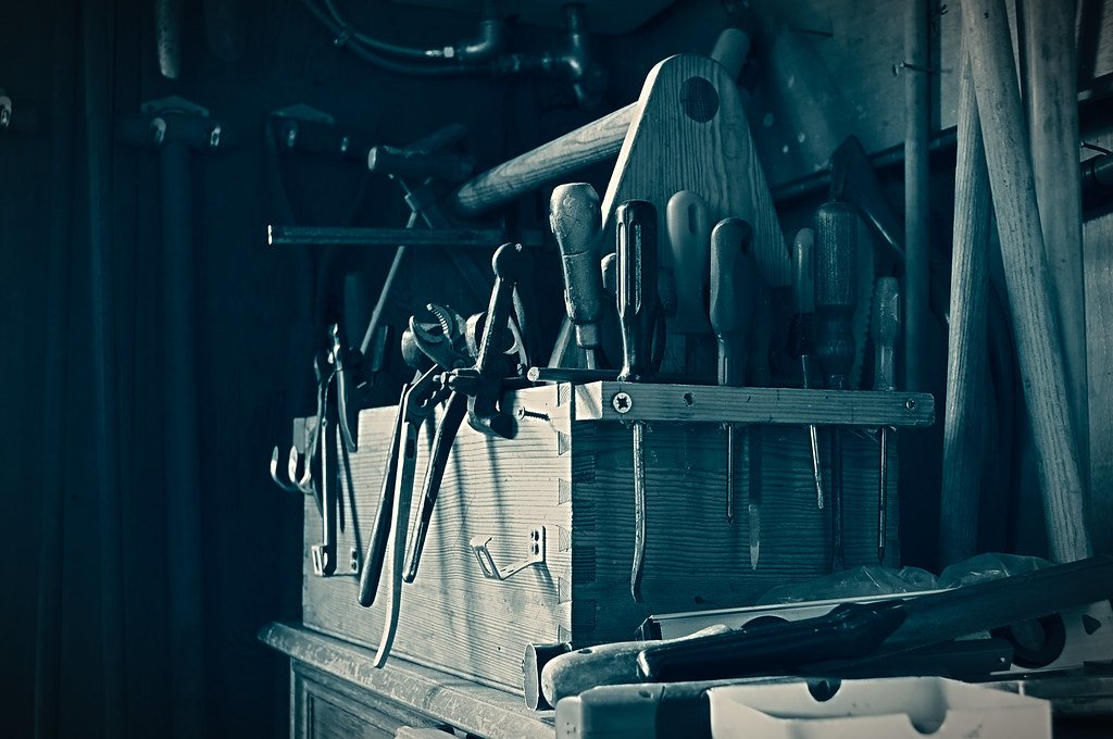 An open toolbox with tools laid out