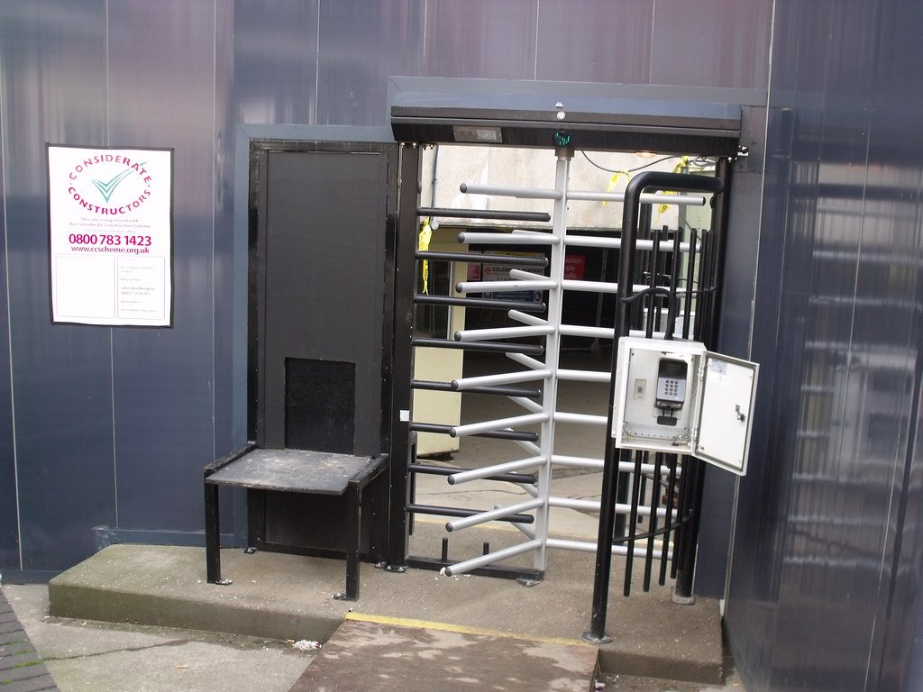 A turnstile gate controlling entry to a site